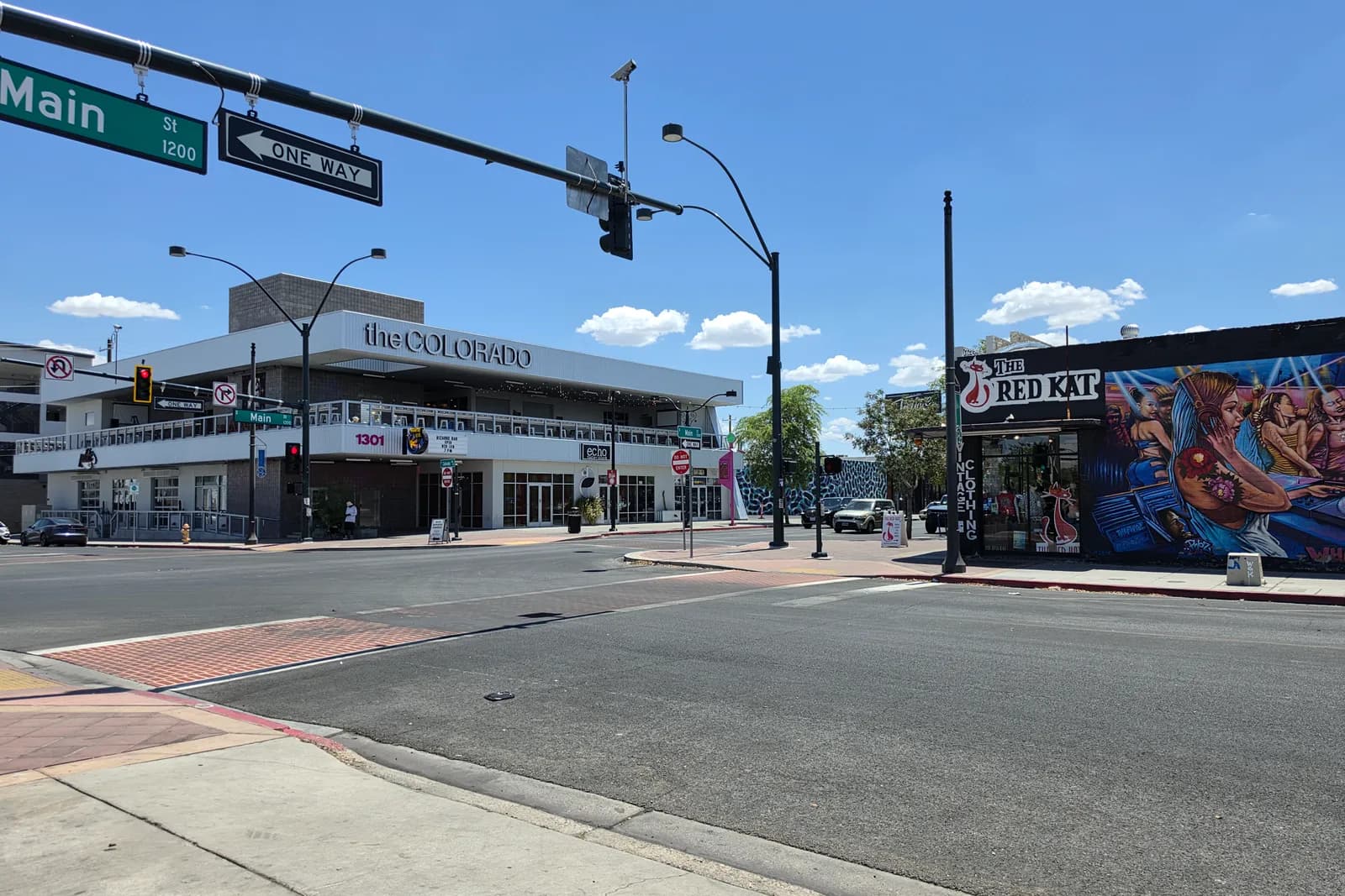 The mid-century Colorado building at Main Street and Colorado Avenue in the Las Vegas Arts District, its clean white facade beside a large mural on the Red Kat vintage store.