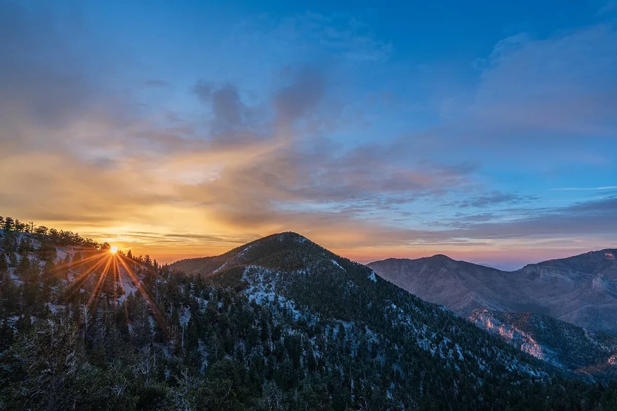 A mountain ridgeline silhouetted at sunset